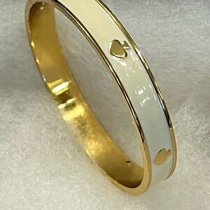 Kate Spade Spot the Spade enamel hinged bangle bracelet in a cream and gold